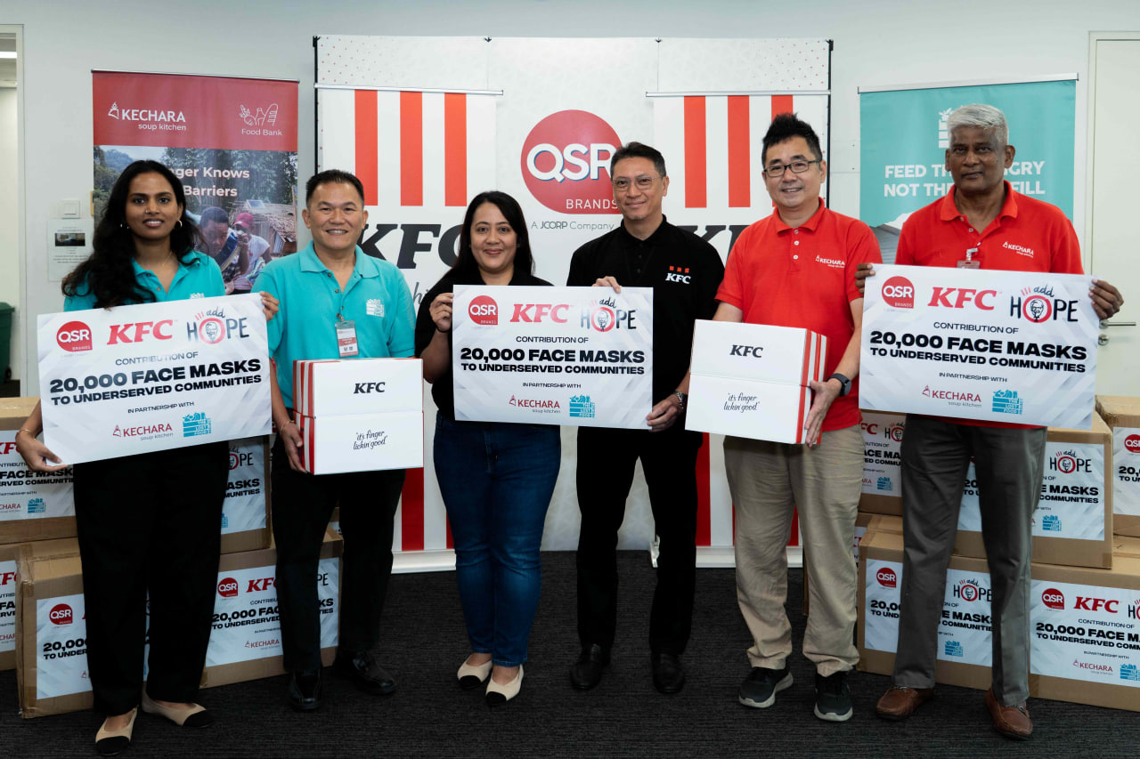 Representatives from QSR Brands and KFC Malaysia presenting the 20,000 face masks contribution to NGO partners